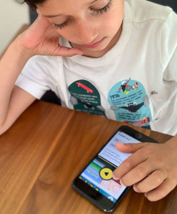 Child using the boom library application on a cellphone