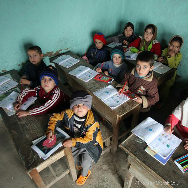 Students in a classroom with open books on their desks