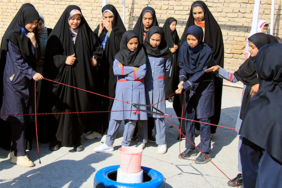 Young girls trying to solve a problem by holding ropes