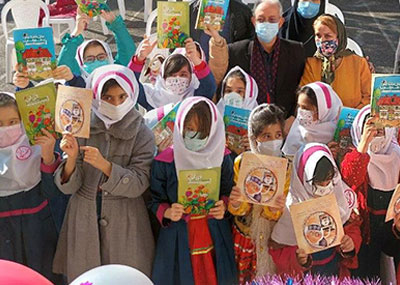 Group of students holding up books