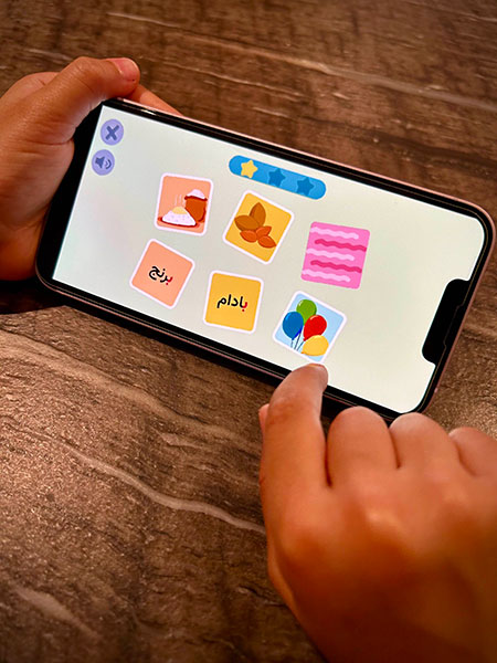Little child playing with TooTak application on a cellphone